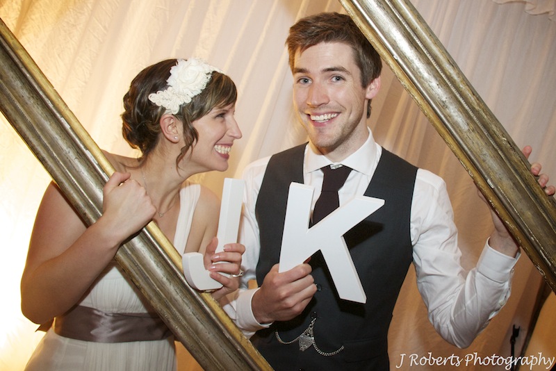 Bride and groom at photo booth - wedding photography